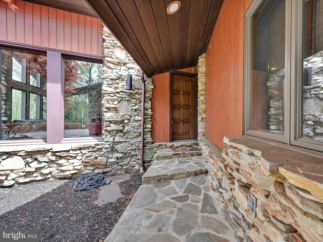 view of exterior entry featuring stone siding