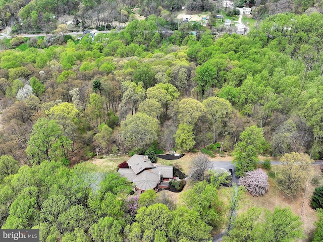 birds eye view of property with a forest view