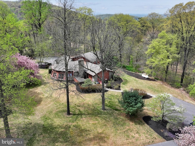 drone / aerial view featuring a forest view