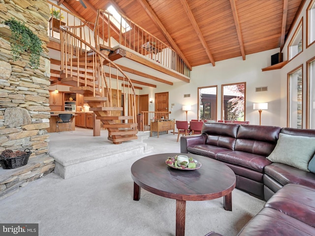 living room with visible vents, high vaulted ceiling, stairway, light colored carpet, and wooden ceiling