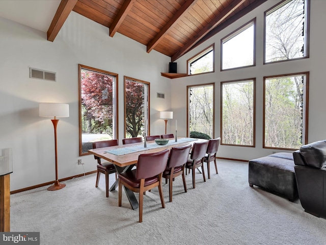 dining space with visible vents, beamed ceiling, baseboards, wooden ceiling, and carpet