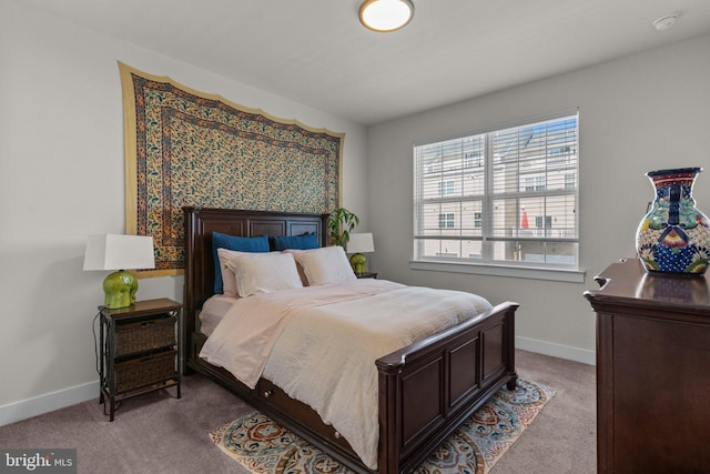 carpeted bedroom featuring baseboards