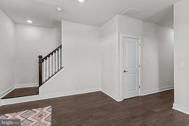interior space with baseboards, recessed lighting, wood finished floors, and visible vents