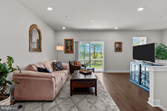 living room featuring recessed lighting, baseboards, and wood finished floors