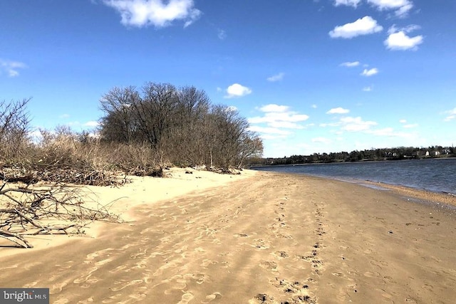 view of road featuring a water view and a view of the beach