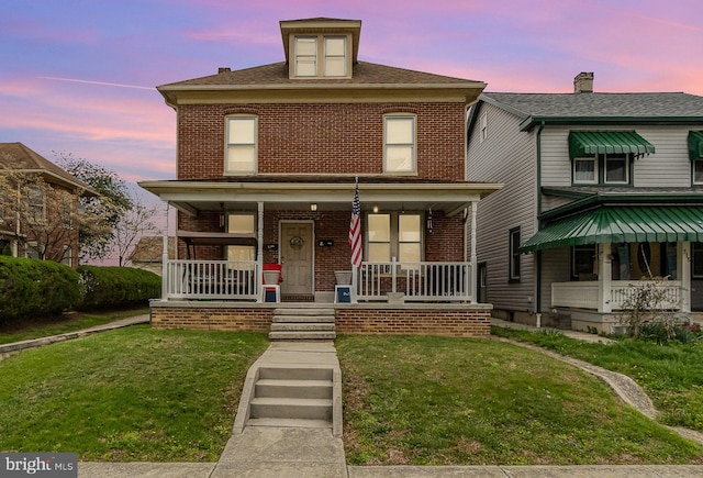 536 S Franklin St, Hanover, PA 17331 - traditional style home with brick siding, a porch, and a yard