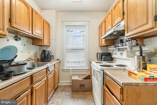 536 S Franklin St, Hanover, PA 17331 - kitchen featuring light tile patterned floors, electric range, under cabinet range hood, light countertops, and a toaster