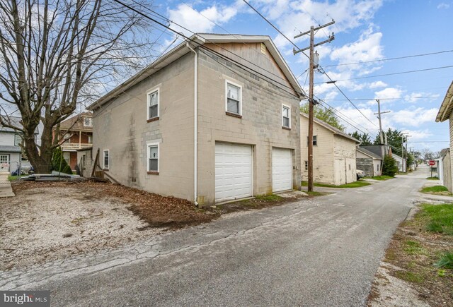 536 S Franklin St, Hanover, PA 17331 - view of property exterior featuring a garage, concrete block siding, and aphalt driveway