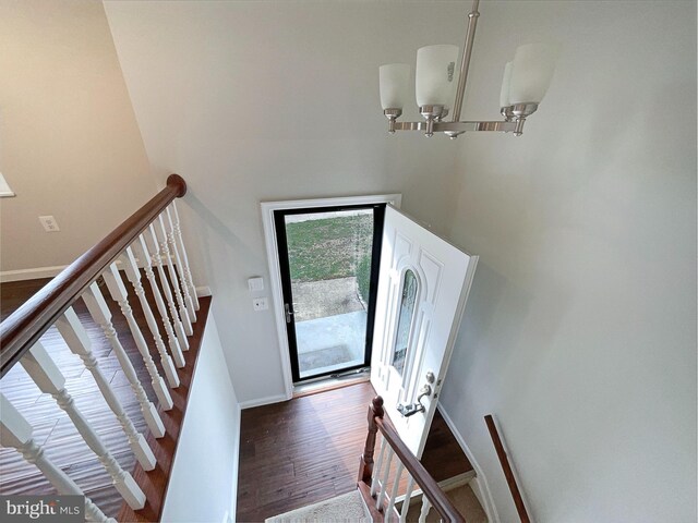 12702 Applecross Dr, Clinton, MD 20735 - entrance foyer with stairs, an inviting chandelier, baseboards, a towering ceiling, and wood finished floors