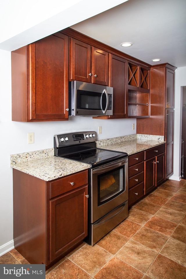kitchen featuring stainless steel appliances, light stone counters, open shelves, and recessed lighting