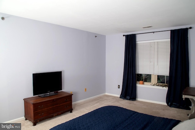 carpeted bedroom featuring baseboards and visible vents