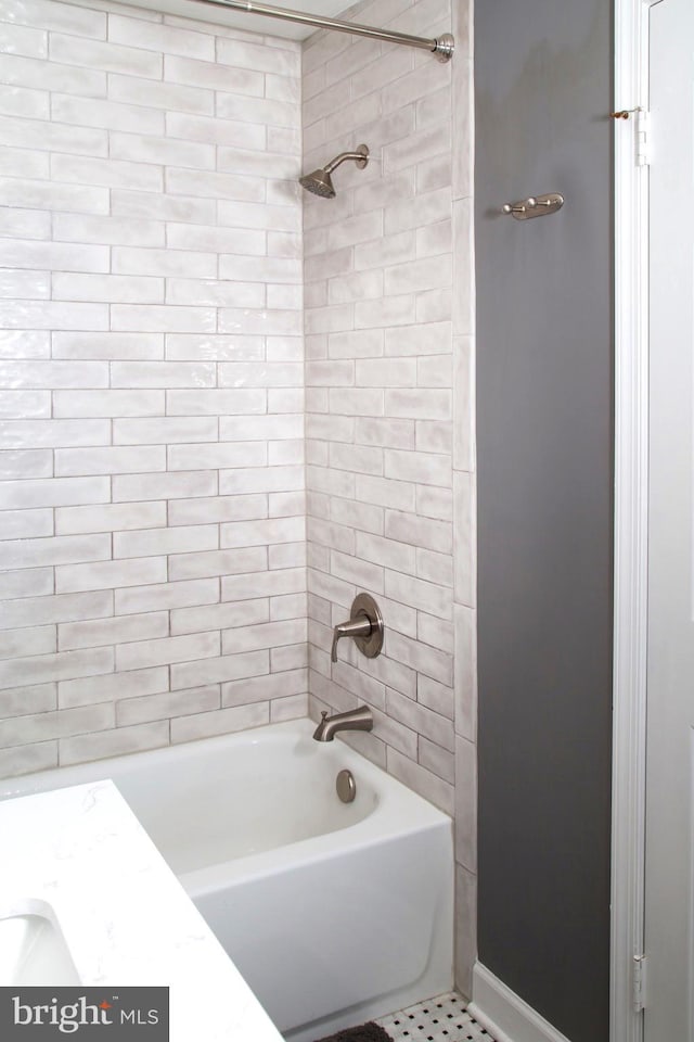 full bathroom with  shower combination and baseboards