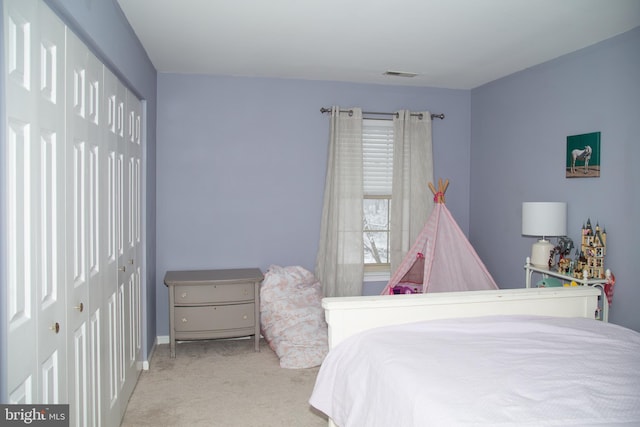 bedroom featuring carpet floors, baseboards, a closet, and visible vents