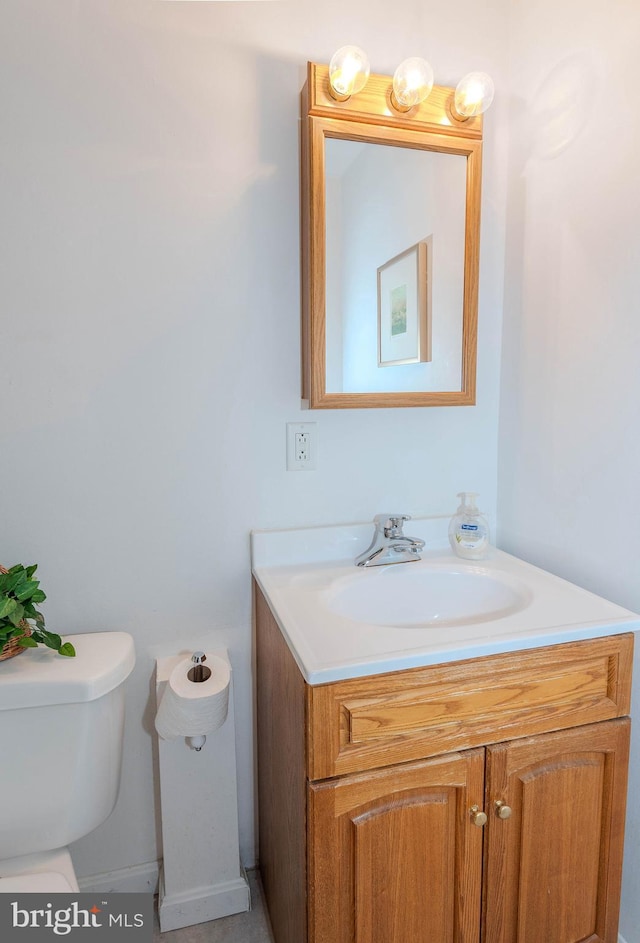 half bath featuring toilet and vanity