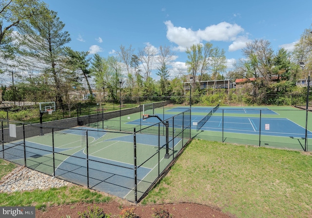 view of sport court featuring fence, a lawn, and community basketball court