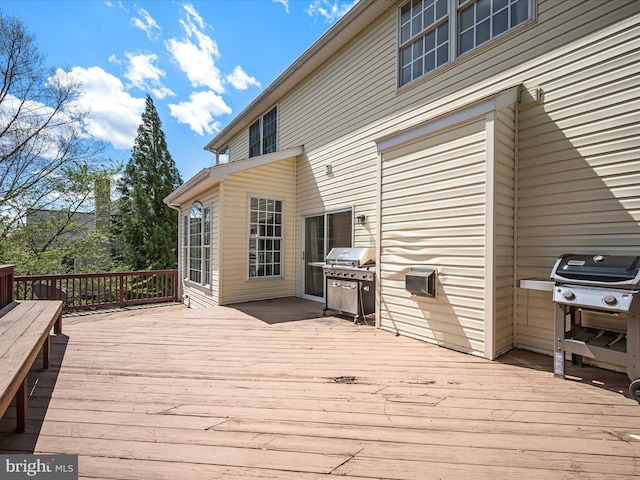 wooden deck featuring a grill