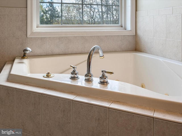 full bath with plenty of natural light and a jetted tub