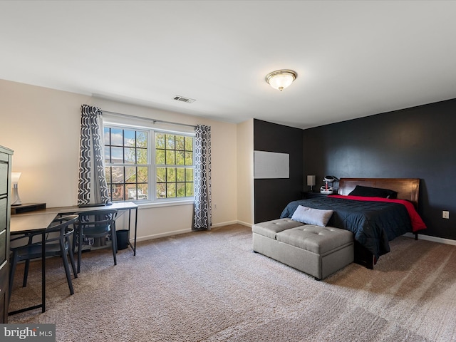 carpeted bedroom with visible vents and baseboards