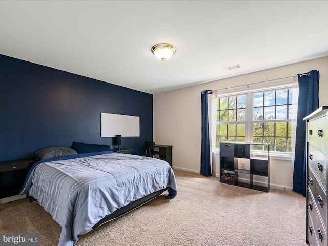 bedroom featuring baseboards, carpet flooring, and visible vents
