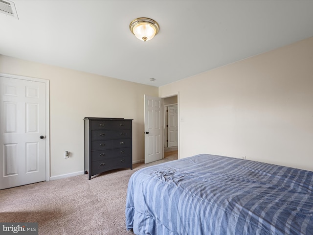 bedroom with baseboards, visible vents, and carpet