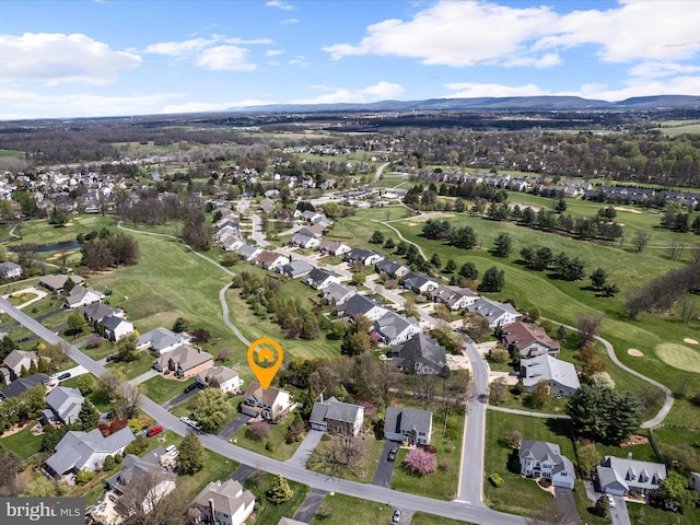 birds eye view of property with view of golf course, a mountain view, and a residential view