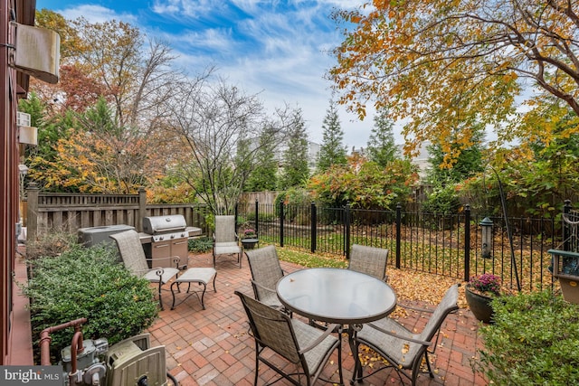 view of patio with fence, outdoor dining space, and area for grilling