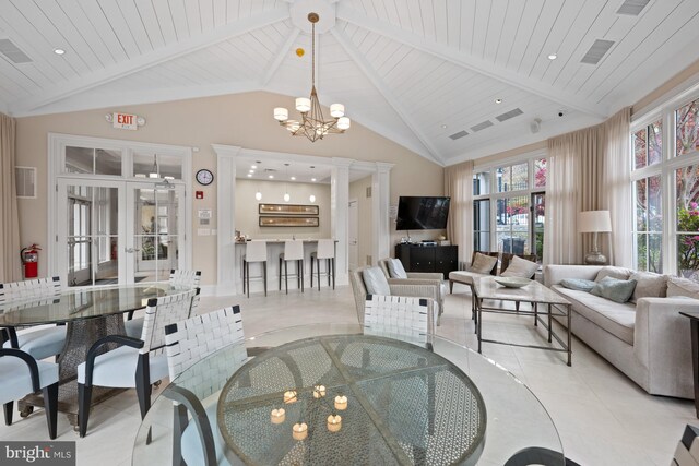 tiled dining room with an inviting chandelier, wood ceiling, beamed ceiling, and french doors