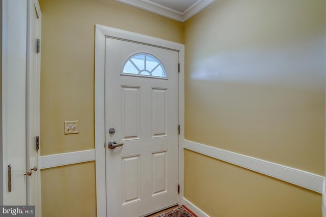 entryway featuring crown molding and baseboards