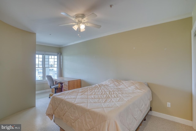 carpeted bedroom featuring baseboards, a ceiling fan, and crown molding