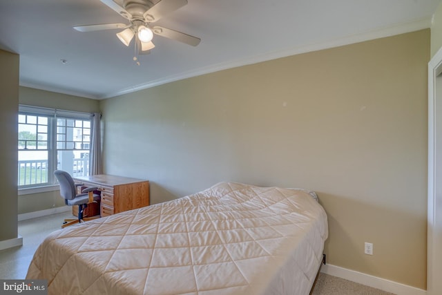 carpeted bedroom with crown molding, ceiling fan, and baseboards