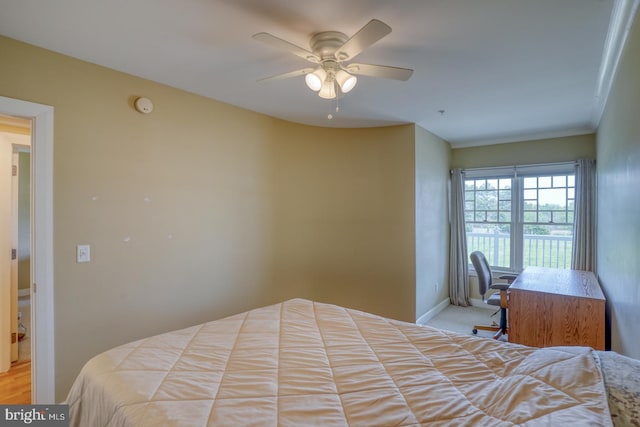 bedroom with ceiling fan and baseboards