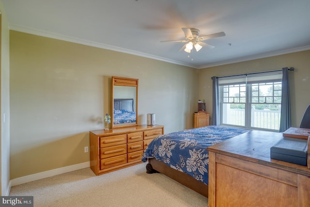 bedroom with ornamental molding, ceiling fan, light carpet, and baseboards