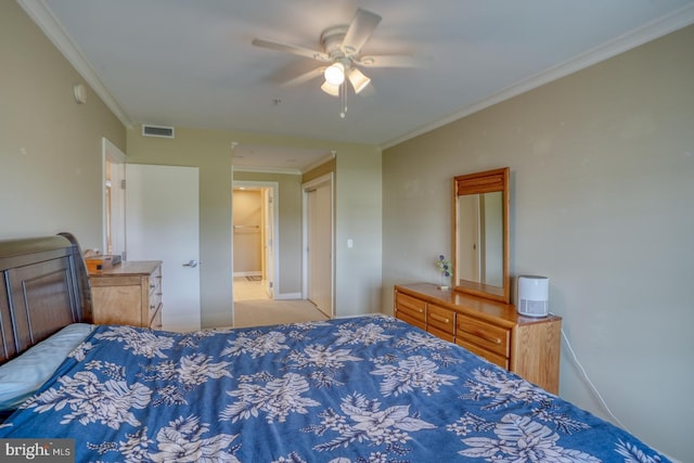 bedroom with carpet floors, ceiling fan, baseboards, visible vents, and crown molding