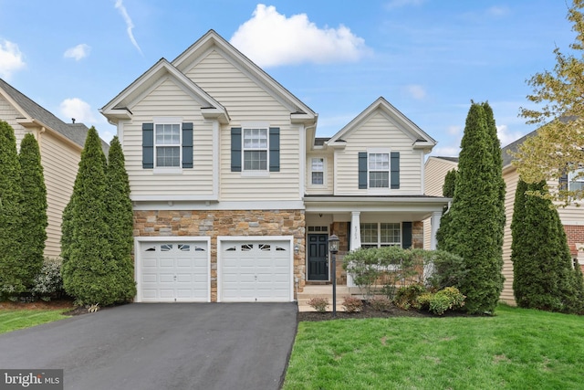 craftsman inspired home with driveway, stone siding, an attached garage, a front lawn, and a porch