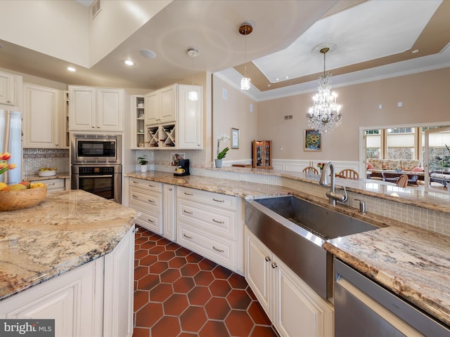 32828 Murray Rd, Frankford, DE 19945 - kitchen with ornamental molding, a raised ceiling, light stone countertops, and stainless steel appliances