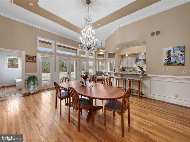 32828 Murray Rd, Frankford, DE 19945 - dining space featuring light wood-style flooring, visible vents, crown molding, an inviting chandelier, and wainscoting