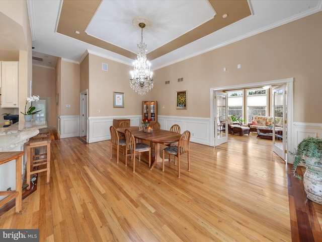 32828 Murray Rd, Frankford, DE 19945 - dining room featuring crown molding, light wood finished floors, a raised ceiling, an inviting chandelier, and wainscoting
