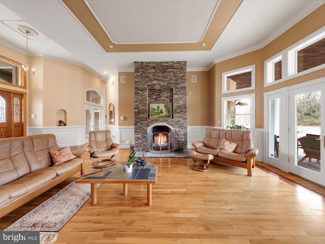 32828 Murray Rd, Frankford, DE 19945 - living room with ornamental molding, wood finished floors, wainscoting, and a stone fireplace