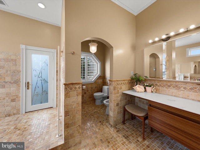 32828 Murray Rd, Frankford, DE 19945 - full bath with tile walls, a wainscoted wall, ornamental molding, toilet, and a bidet