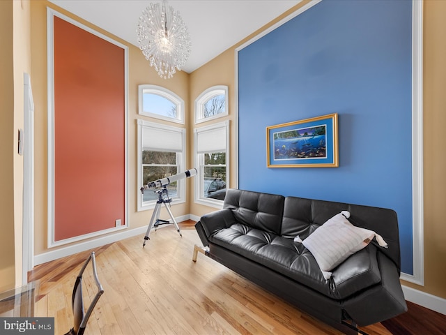 32828 Murray Rd, Frankford, DE 19945 - living room featuring baseboards, a notable chandelier, and hardwood / wood-style flooring