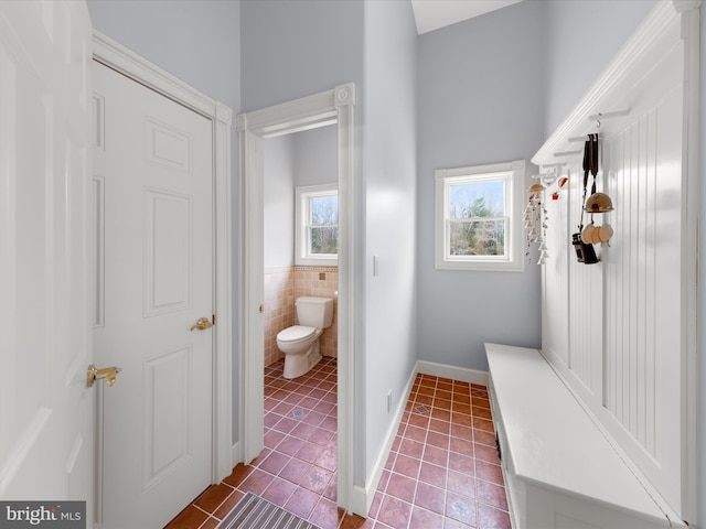32828 Murray Rd, Frankford, DE 19945 - bathroom with tile walls, toilet, baseboards, tile patterned floors, and a wainscoted wall