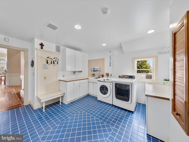 32828 Murray Rd, Frankford, DE 19945 - clothes washing area featuring washing machine and clothes dryer, dark tile patterned floors, visible vents, cabinet space, and recessed lighting