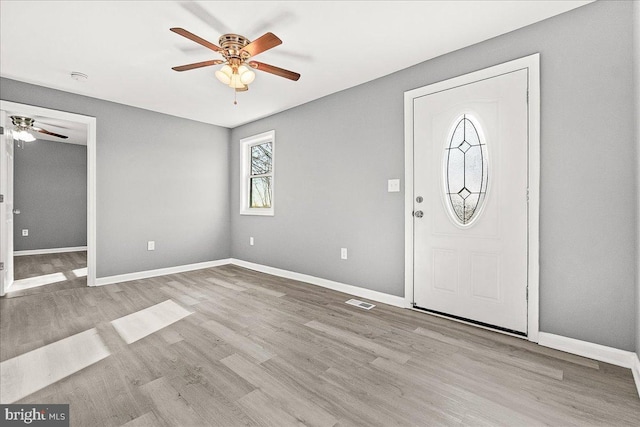 entrance foyer with baseboards, visible vents, wood finished floors, and a ceiling fan
