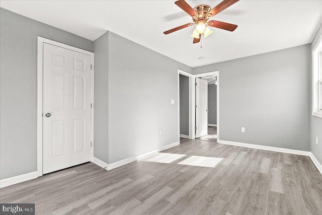 unfurnished bedroom with baseboards, light wood-type flooring, and ceiling fan