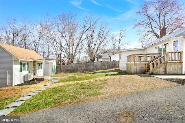 view of yard featuring fence and a deck