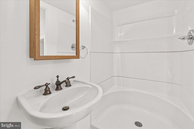 full bathroom with a sink and walk in shower