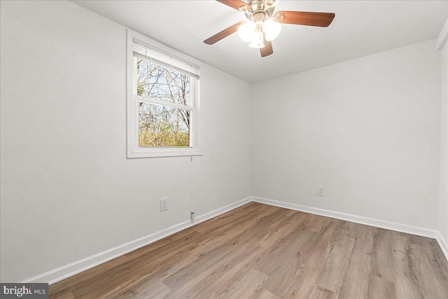 unfurnished room featuring baseboards, wood finished floors, and a ceiling fan