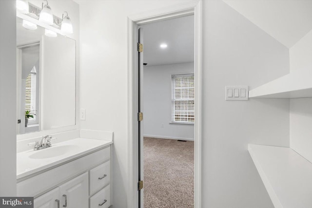 bathroom featuring baseboards and vanity