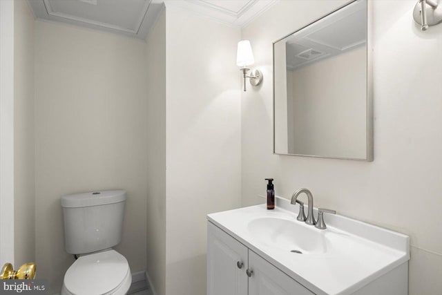 bathroom featuring toilet, crown molding, and vanity