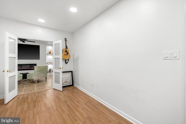 interior space with french doors, light wood-style flooring, recessed lighting, and baseboards